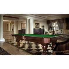 a pool table in the middle of a living room with black and white checkered flooring