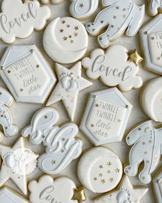 cookies decorated with white and gold icing are displayed on a table, surrounded by stars