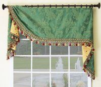 a window with a green and yellow valance hanging from it's side next to a fountain