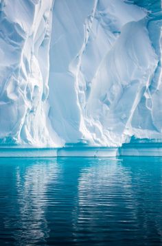 an iceberg in the water with snow on it