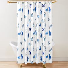 a white shower curtain with blue cats on it