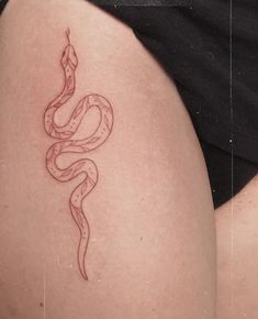 a woman's thigh with a snake tattoo on it