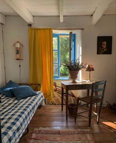 a bedroom with a bed, desk and window