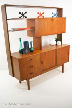 a wooden shelf that has some vases on top of it and two shelves above it