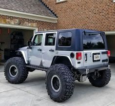 a jeep parked in front of a garage