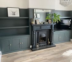 a living room filled with furniture and a fire place in front of a tv mounted on a wall