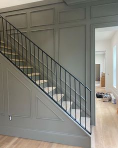 an empty room with stairs and hard wood flooring