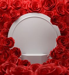 a white box surrounded by red roses in the shape of a circle with a hole