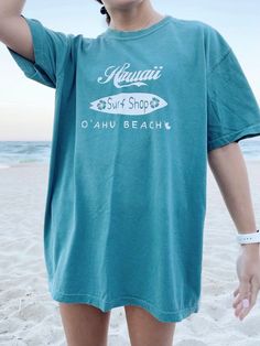 "Emerald Comfort Colors O'ahu Beach, Hawaii surf shop t-shirt. I also have this design on a hoodie in my shop :) ✰ MODEL INFO: ✰ Height: 5'4\" Size: normally wears a small, but is modeling a large for an oversized look. ★ MATERIAL: ★ 100% cotton" T Shirt Outfit Summer, Surf Shop Shirts, Surf Shops, Vsco Outfits, Summer Gardening, Hawaii Shirts, Aesthetic Hoodies, Hawaiian Summer, Beachy Dresses