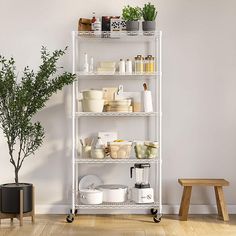 a white shelving unit with pots, pans and other kitchen items on it