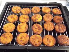 some food is cooking on a grill with it's tray ready to be cooked