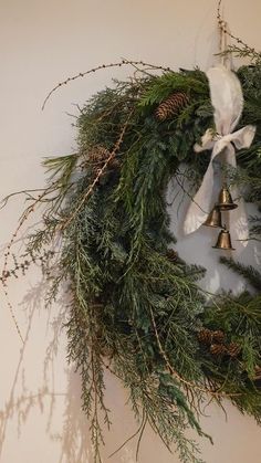 a wreath with bells hanging on the wall