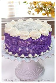 a purple cake with white flowers on top