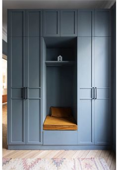 an empty room with blue cupboards and yellow cushion