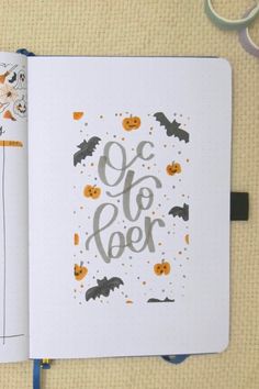 an open notebook with halloween themed lettering