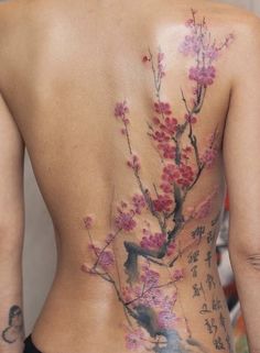 the back of a woman's body with flowers painted on her stomach and chest