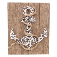 an anchor made out of string and rope on a wooden background with the word love spelled in