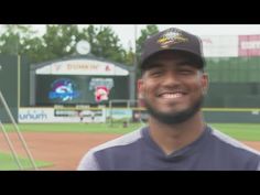 a baseball player is smiling at the camera