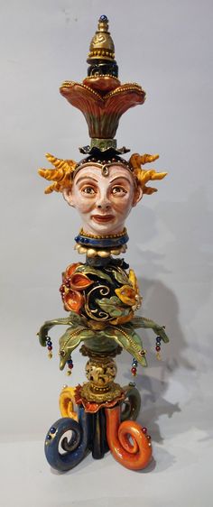 a colorful statue with an elaborate hat on top