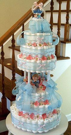 a three tiered cake sitting on top of a table next to a stair case