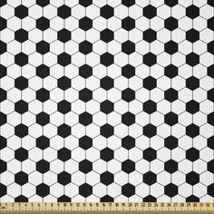 black and white hexagonal tile pattern with ruler on the bottom right hand side