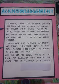 a pink and white sign with words written on it in front of a colorful background