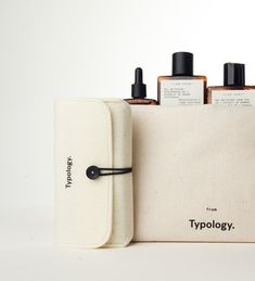 three bottles in a pouch next to each other on a white surface with the words typollogy printed on it