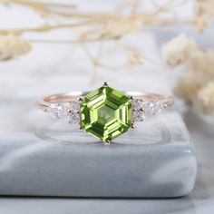 ► FEATURES Geometrical cut August birthstone peridot ring, hexagon cut natural peridot gemstone with marquise cut moissanites side stones, it is very unique and elegant. Center stone: Peridot Weight: 2.0 Carat Stone Size: 7X7mm  Shape: Hexagon cut Shank Width: Approx. 1.6mm Side stone: 0.2 carat 4x2mm marquise cut and 1.5mm round cut moissanites or CZ(Silver) The center stone of the ring can be replaced with other different kinds of gemstone such as morganite, aquamarine, amethyst, citrine, opal Peridot Wedding Ring, Peridot Engagement Ring, Ring Hexagon, Peridot Engagement Rings, Wedding Ring For Women, Gemstone Wedding Rings, Engagement Ring Unique, Unique Roses, August Birthstone