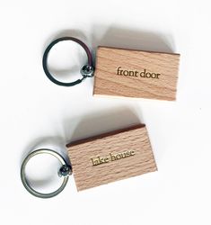 two wooden keychains with the words front door on them