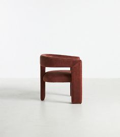 a brown chair sitting on top of a white floor