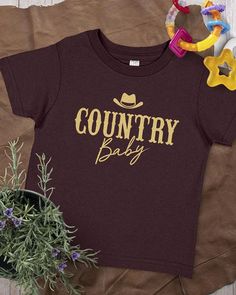 Our  Country Baby® T-shirt is made with 5 oz. 100% soft cotton (Heather colors contain 10% cotton). Girls Clothing Stores, Country Girls Outfits, Top Baby Products, Graphic Tee Shirt, Boy Tees, Jersey Tee, Gender Neutral Baby, Graphic Tee Shirts, Baby Tshirts