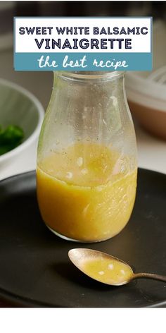 a glass jar filled with liquid sitting on top of a black plate