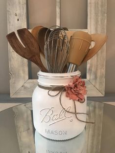 a mason jar filled with kitchen utensils