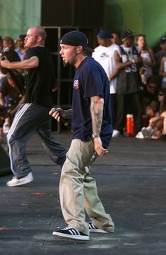 a group of men standing next to each other on top of a stage in front of a crowd