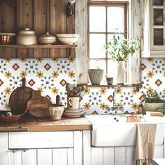 a kitchen with sunflowers painted on the backsplash and wooden cabinets,