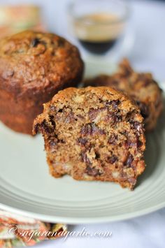 two muffins sitting on top of a white plate