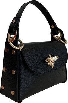 a black handbag with a bee on the front and gold hardwares around it