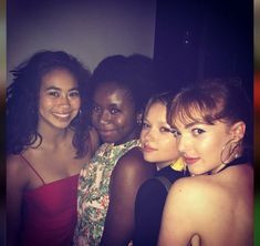 four women are posing for a photo together