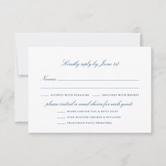 a white wedding response card with blue ink