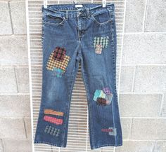 an old pair of jeans with patches on them