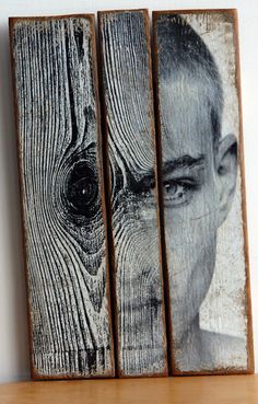 three wooden blocks with an image of a man's face and eye on them