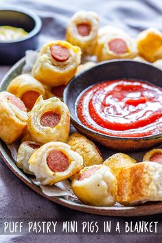 mini pigs in a blanket on a plate next to dipping sauce and breadsticks