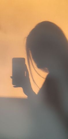 a blurry image of a woman holding a cell phone