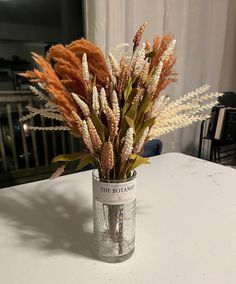 a vase with some flowers in it on a table