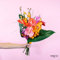 a person holding a bouquet of flowers in front of a pink background with the words hawaii lei written on it