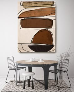 a table with two chairs and a painting on the wall