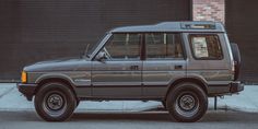 an suv parked in front of a garage door