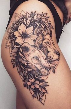 a woman's thigh with a lion and flowers on it