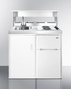 a white kitchen with a sink, stove and cupboards in front of the wall