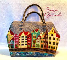 a handbag with an image of buildings painted on it